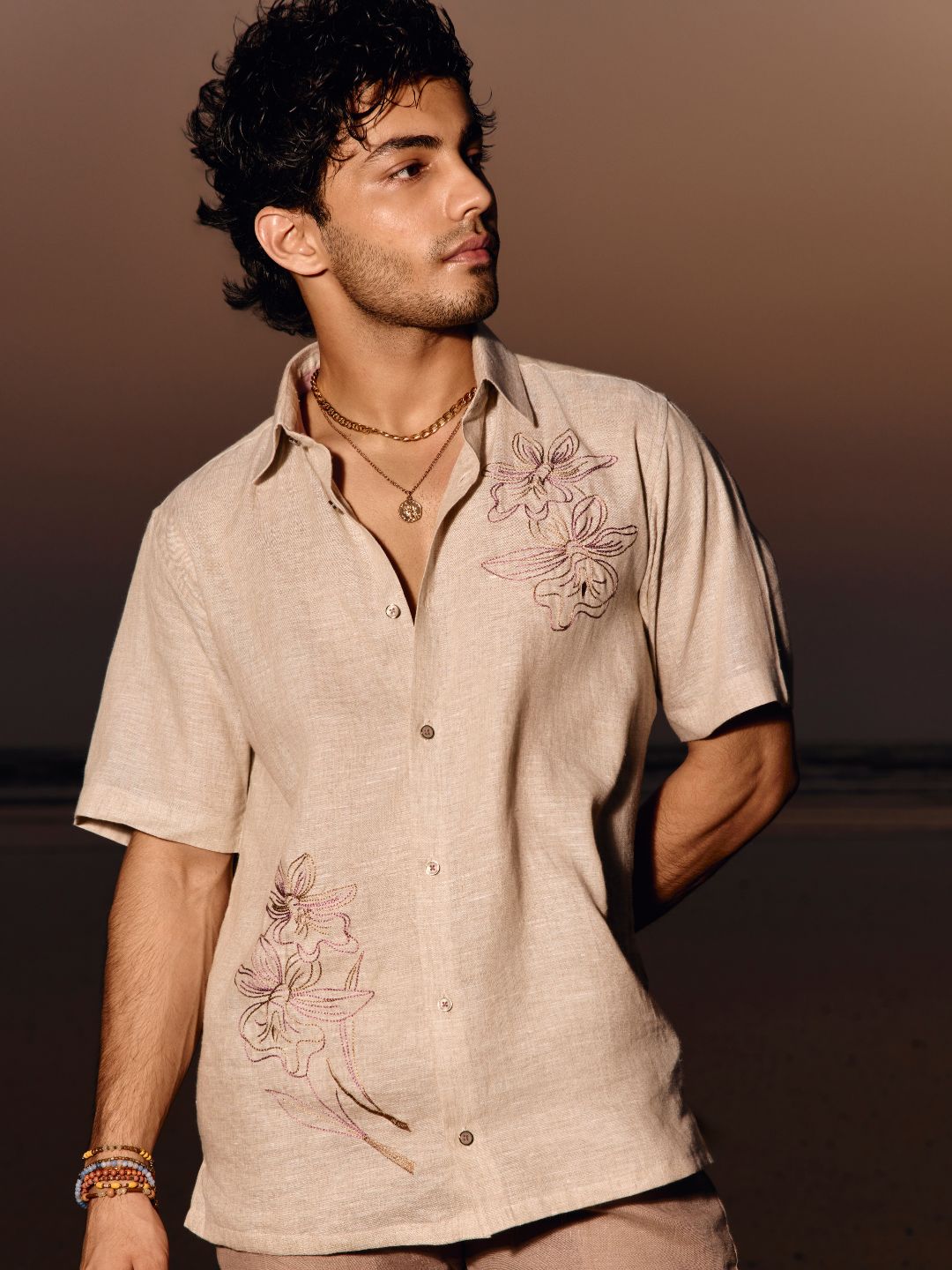 Man wearing khaki floral embroidered linen half sleeve shirt with regular collar